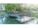 Lakefront property with a dock and lush landscaping, exemplifying a serene and picturesque waterfront living experience at 7851 Green Cove Ct, Denver, NC 28037