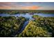 Stunning aerial view of a lake surrounded by lush, green landscapes and vibrant sunset at 8086 Summit Ridge Dr, Catawba, NC 28609