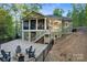 Back exterior with a screened in porch, outdoor seating area and wooded backyard at 8086 Summit Ridge Dr, Catawba, NC 28609