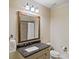 Bathroom featuring a vanity with granite counters and decorative mirror at 8086 Summit Ridge Dr, Catawba, NC 28609