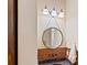 Stylish powder room with a decorative copper backsplash, round mirror, and granite countertop at 8086 Summit Ridge Dr, Catawba, NC 28609