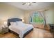 Bright bedroom featuring a large window, hardwood floors, a comfortable bed, and an accent wall at 8086 Summit Ridge Dr, Catawba, NC 28609
