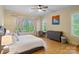 Comfortable bedroom featuring large windows with natural light, light hardwood floors, and a desk at 8086 Summit Ridge Dr, Catawba, NC 28609