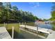 Exterior lake view featuring a private boat dock for seamless water access and recreation at 8086 Summit Ridge Dr, Catawba, NC 28609