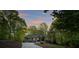 A beautiful green home nestled among mature trees and an inviting driveway at 8086 Summit Ridge Dr, Catawba, NC 28609