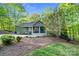 A charming green home featuring a well-manicured lawn, stone pathway, and inviting covered porch at 8086 Summit Ridge Dr, Catawba, NC 28609