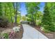 A winding driveway leads to a charming home set among tall trees and manicured landscaping at 8086 Summit Ridge Dr, Catawba, NC 28609