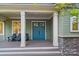 Inviting covered front porch features comfortable seating and a stylish double door entrance at 8086 Summit Ridge Dr, Catawba, NC 28609
