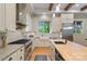 Well-lit kitchen features light wood floors, stainless steel appliances, and a farm-style sink at 8086 Summit Ridge Dr, Catawba, NC 28609