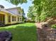 Expansive backyard with lush green grass, mature trees, and landscaped features at 8708 Soaring Eagle Ln, Waxhaw, NC 28173