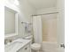Bathroom showcasing a single sink vanity, mirror, and bathtub with shower at 8708 Soaring Eagle Ln, Waxhaw, NC 28173
