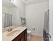 Well-lit bathroom features a large mirror, updated vanity, and tiled floor at 8708 Soaring Eagle Ln, Waxhaw, NC 28173