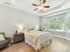 Relaxing bedroom features a bay window and a ceiling fan at 8708 Soaring Eagle Ln, Waxhaw, NC 28173