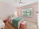Cozy bedroom with natural light, pink walls and carpeted flooring for a comfortable and stylish space at 8708 Soaring Eagle Ln, Waxhaw, NC 28173