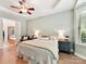 This primary bedroom has wood floors, a ceiling fan, neutral paint and is well lit at 8708 Soaring Eagle Ln, Waxhaw, NC 28173