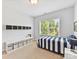 Bedroom with a twin bed, neutral carpet, built-in shelving and a window for natural light at 8708 Soaring Eagle Ln, Waxhaw, NC 28173