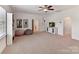 Bonus room showcases ample natural light, neutral carpet and a media cabinet for entertainment at 8708 Soaring Eagle Ln, Waxhaw, NC 28173