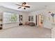 Bright bonus room with a window, carpet, ceiling fan and ample space for various activities at 8708 Soaring Eagle Ln, Waxhaw, NC 28173