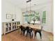 Bright dining room features wood floors, a large window, and modern light fixture at 8708 Soaring Eagle Ln, Waxhaw, NC 28173