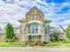 Beautiful stone and brick exterior of a grand two story home with balcony at 8708 Soaring Eagle Ln, Waxhaw, NC 28173