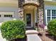 Charming stone archway frames the front door, accented by lush landscaping and flowerpots at 8708 Soaring Eagle Ln, Waxhaw, NC 28173