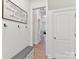 Hallway features decorative signage, coat hooks, storage bench and views into other rooms at 8708 Soaring Eagle Ln, Waxhaw, NC 28173