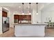 Modern kitchen showcasing a granite island, stainless steel appliances and rich brown cabinetry at 8708 Soaring Eagle Ln, Waxhaw, NC 28173