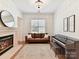 Elegant living room featuring a fireplace, a modern sofa, and a grand piano at 8708 Soaring Eagle Ln, Waxhaw, NC 28173