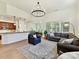 Open living room and kitchen area with a large sectional and bar top seating at 8708 Soaring Eagle Ln, Waxhaw, NC 28173
