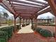 A shaded community pergola and walkway surrounded by lush landscaping and views of the neighborhood at 8708 Soaring Eagle Ln, Waxhaw, NC 28173