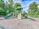 A colorful playground with slides, a climbing wall, and a soft ground cover for safety and fun at 8708 Soaring Eagle Ln, Waxhaw, NC 28173