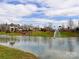 Community pond with fountain, surrounded by lush landscaping, playground, and upscale homes at 8708 Soaring Eagle Ln, Waxhaw, NC 28173