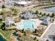 Aerial view of community pool with slide, pond, and landscaping at 8708 Soaring Eagle Ln, Waxhaw, NC 28173