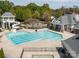 Community pool with slide, lounge area, and lush landscaping at 8708 Soaring Eagle Ln, Waxhaw, NC 28173