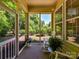 Charming screened porch features rocking chairs with a view of the landscaped backyard at 8708 Soaring Eagle Ln, Waxhaw, NC 28173