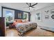 Bedroom featuring hardwood floors, two windows, blue accent wall, and a bed with a quilt at 901 Central Dr, Kannapolis, NC 28083