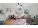 Bright bedroom features hardwood floors, windows and a pink bed, filled with stuffed animals and toys at 901 Central Dr, Kannapolis, NC 28083