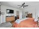 Bedroom featuring a ceiling fan, TV, wood dresser, and hardwood floors at 901 Central Dr, Kannapolis, NC 28083