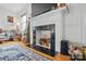 Bright living room with an ornate, decorative fireplace featuring dark tile and a white mantel at 901 Central Dr, Kannapolis, NC 28083