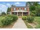 Charming brick two-story home with inviting front porch, columns, and mature landscaping at 901 Central Dr, Kannapolis, NC 28083