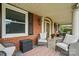 Covered front porch with brick, seating, and an arched front door provides a relaxing outdoor space at 901 Central Dr, Kannapolis, NC 28083