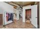 Hallway with wood floors that offers access to other rooms and an interestingly wallpapered half bath at 901 Central Dr, Kannapolis, NC 28083