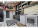 Convenient laundry room with washer, dryer, storage shelves, and a checkered floor at 901 Central Dr, Kannapolis, NC 28083