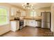 Well-lit kitchen featuring stainless steel appliances, white cabinets, and wood-style flooring at 905 Gantt St, Kings Mountain, NC 28086