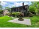 Backyard featuring a fire pit, lawn, and landscaping at 9310 Hunting Ct, Matthews, NC 28105