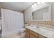 Functional bathroom featuring a vanity, toilet, and a shower-tub with curtain and neutral color scheme at 9310 Hunting Ct, Matthews, NC 28105