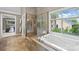 Beautiful bathroom featuring a shower, bathtub, and large windows with ample natural light at 9310 Hunting Ct, Matthews, NC 28105
