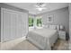 Cozy bedroom featuring a double bed, closet, and window providing natural light and outdoor views at 9310 Hunting Ct, Matthews, NC 28105