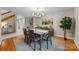 Elegant dining room with a modern chandelier, stylish furniture, and hardwood floors at 9310 Hunting Ct, Matthews, NC 28105