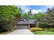 Charming home with a well-maintained lawn, mature trees, and a two-car garage at 9310 Hunting Ct, Matthews, NC 28105